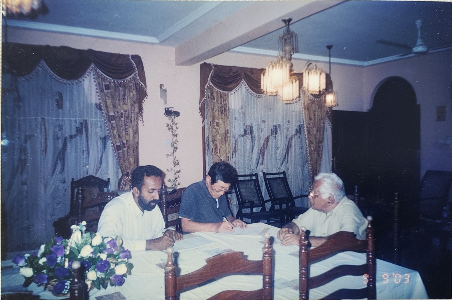Korean buyer signing an off-take agreement in a Sri Lankan home